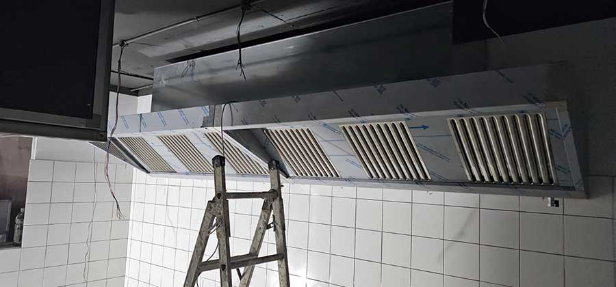 Spiteri Catering installation team fitting extraction canopy and flue pipework at Vivilo Restaurant, Gozo