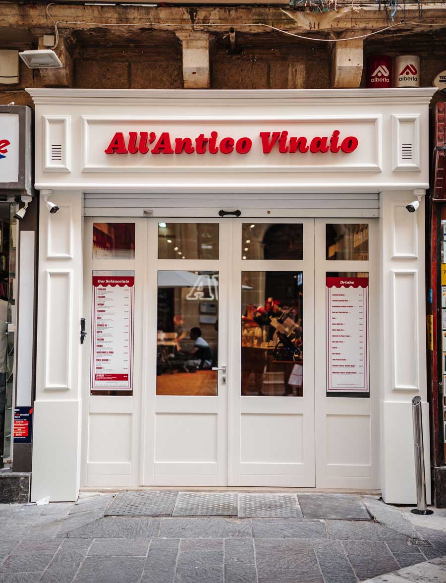 All'Antico Vinaio Valletta interior showing display counter, wall-hung refrigeration, and Berkel slicers