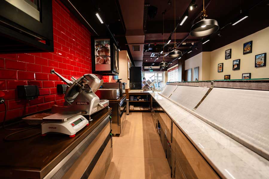 All'Antico Vinaio Valletta counter detail showing Berkel slicers and refrigerated display