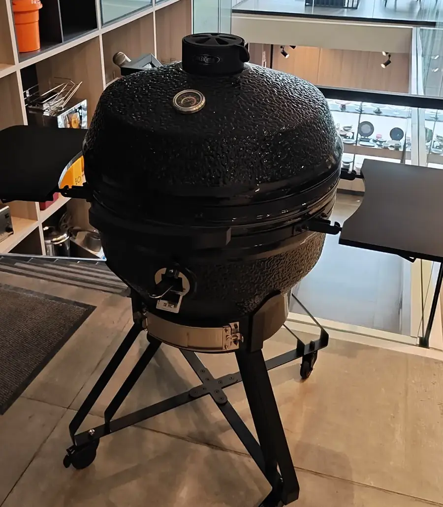Brabura wood-fired pizza oven on display in the Spiteri Catering showroom, matt black body with chimney stack and analogue thermometer