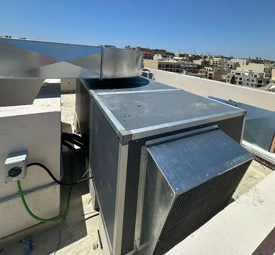 Rooftop duct transition and custom ductwork at Casa Giuseppe Care Home with the Citadel of Victoria in the background