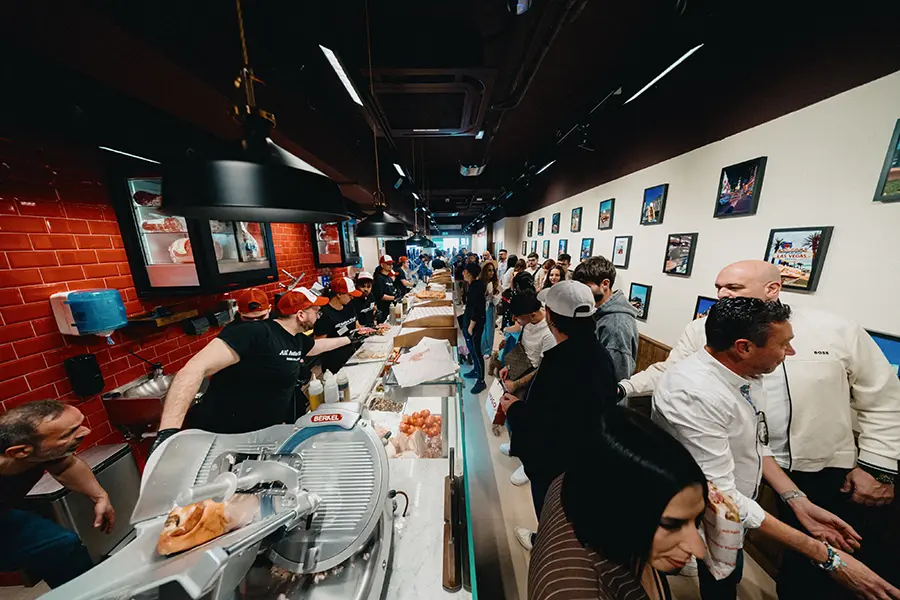 Schiacciata sandwich being assembled on a marble prep surface at All'Antico Vinaio Valletta, with fillings visible