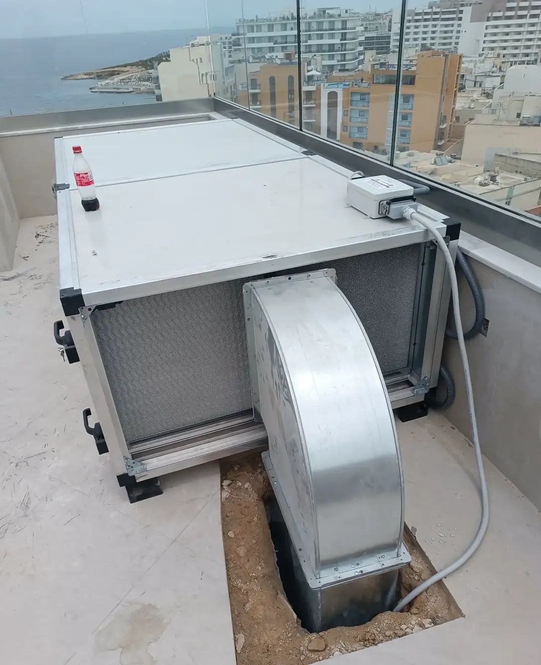 Commercial kitchen extraction canopy installed in a shell-and-core kitchen space during fit-out, with services and cabling still to be completed