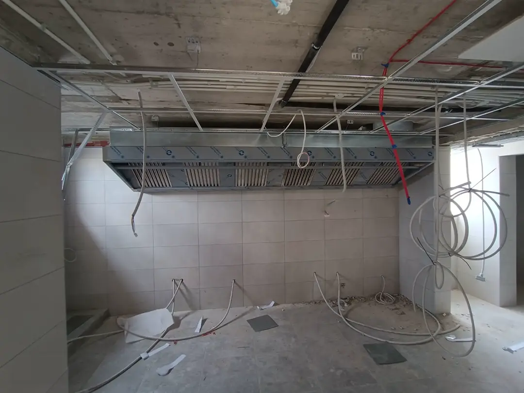 Wall-mounted extraction fan speed controller and electrical isolator fitted to a tiled kitchen wall during installation