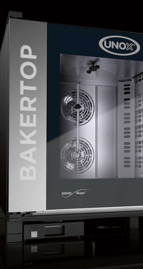 Dramatic studio shot of the Unox BAKERTOP MIND.Maps oven with the door open, showing the twin fan assembly and illuminated stainless steel baking chamber interior