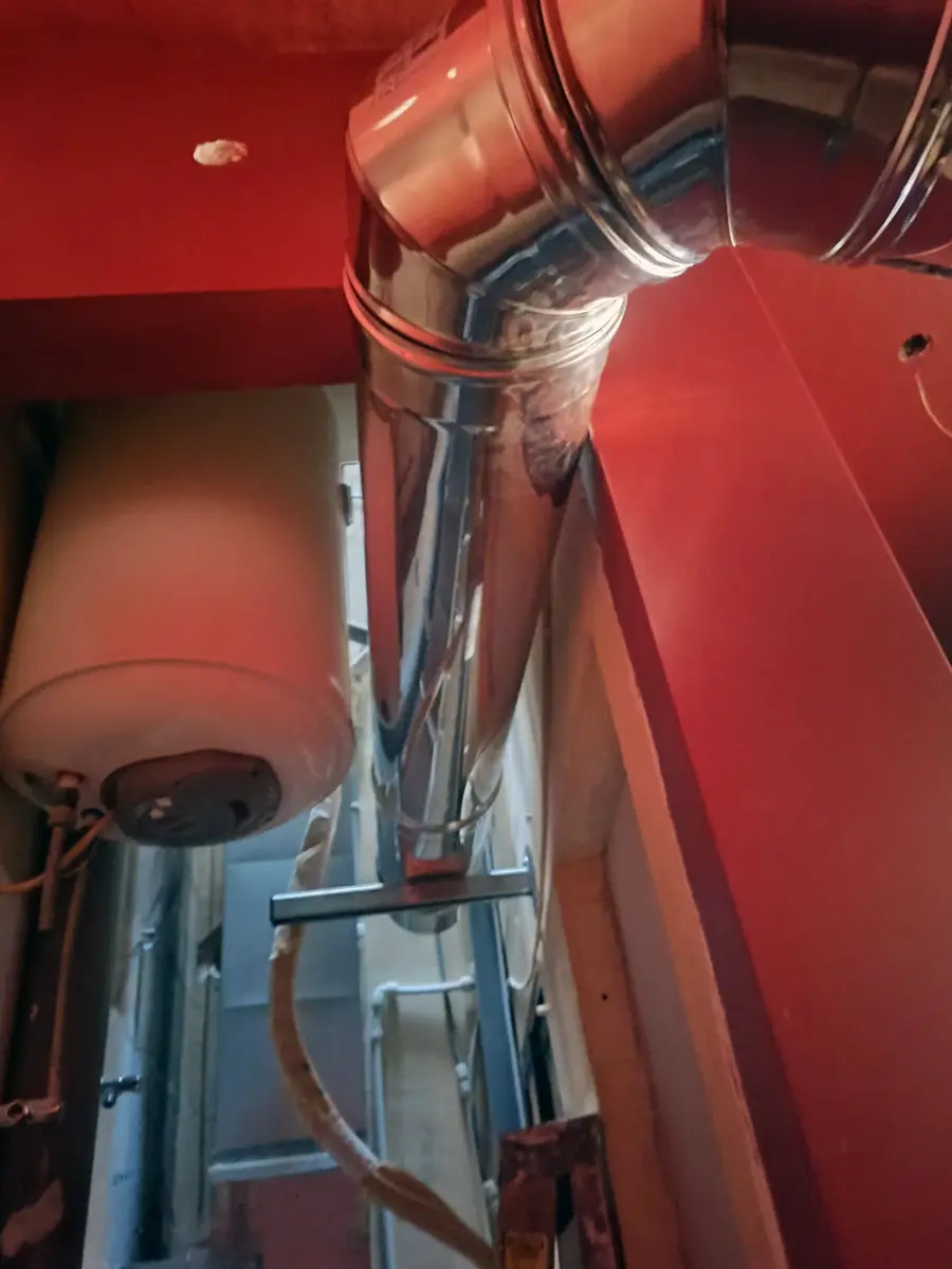 Stainless steel flue from the Valoriani oven running upward through an internal void in the building at Joe's Street Pizza, Nadur