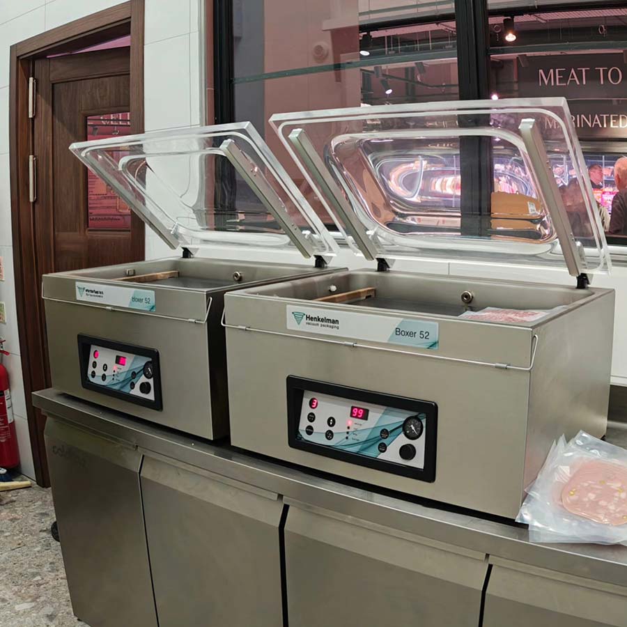 Two Henkelman Boxer 52 double-chamber vacuum packing machines installed at a retail fresh counter