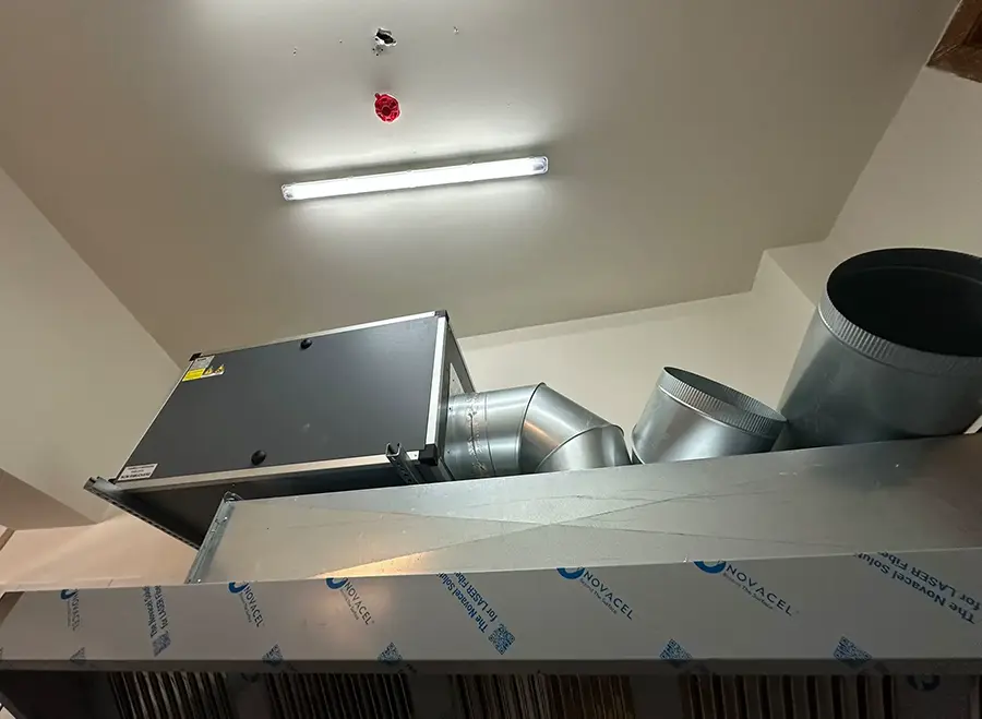 Centrifugal extraction fan unit and aluminium duct transition above commercial kitchen canopy, Naxxar, Malta
